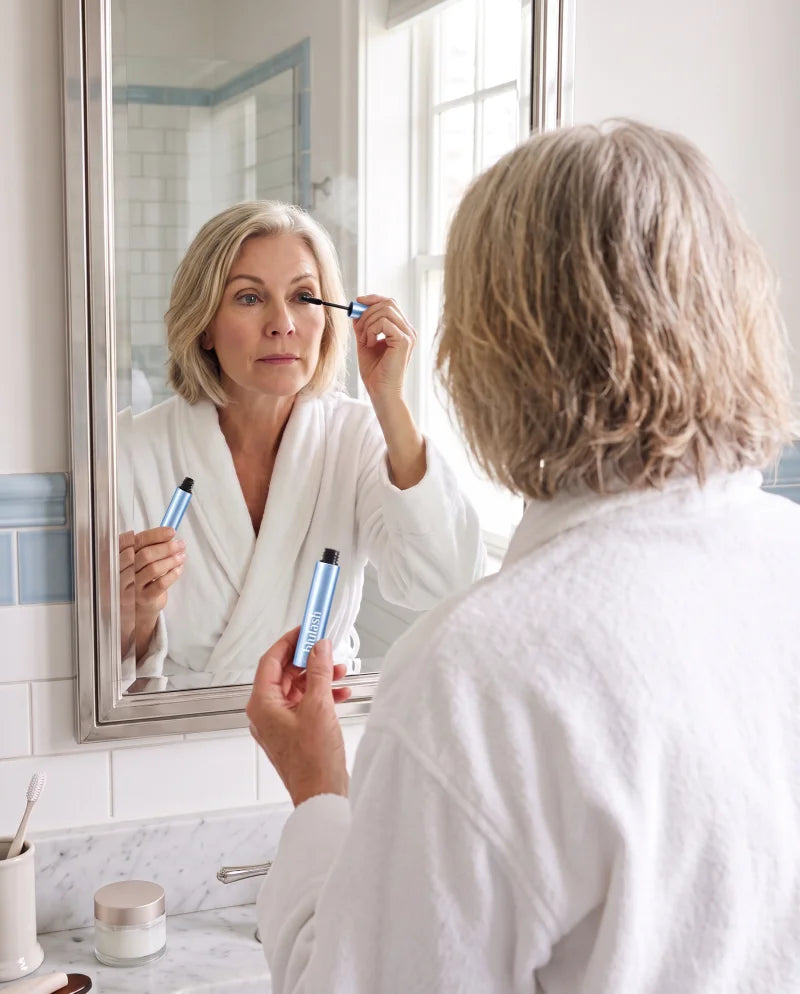 Woman applying Blulash volumizing mascara at a mirror